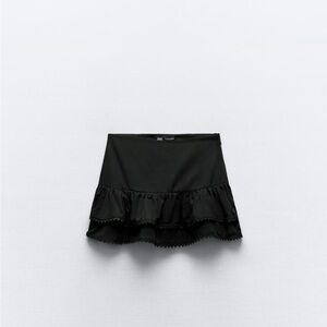 Two Ruffle mini skirts (black and white) one of each